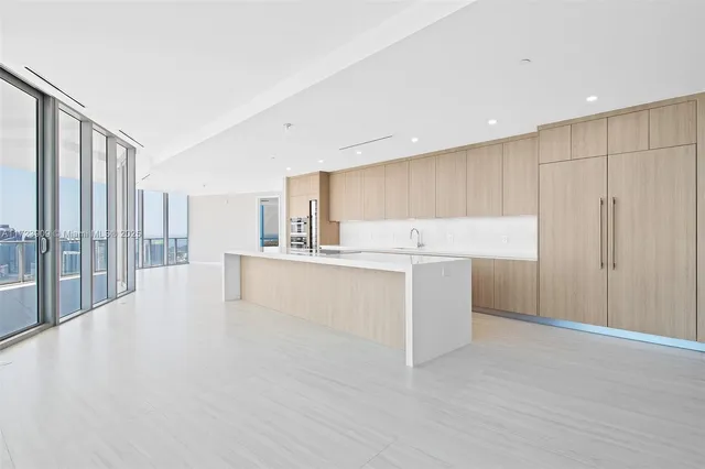 a view of kitchen with granite countertop cabinets and white appliances