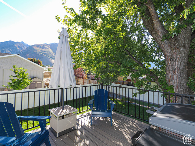 3308 Willow Ridge Road Salt Lake City, UT 84121 - Photo 13 of 59 Elevated deck with composite planking, black metal railing, and mature tree providing natural shade