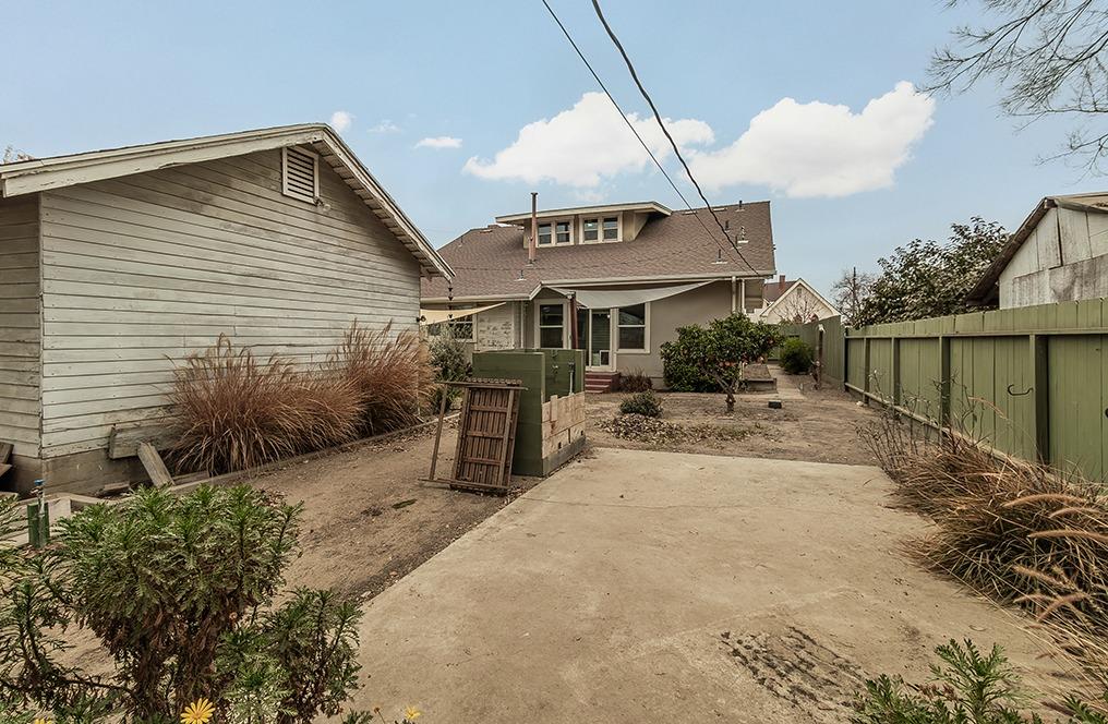 1203 L Street Reedley, CA 93654 - Photo 34 of 40 a view of a patio with a table and chairs under an umbrella