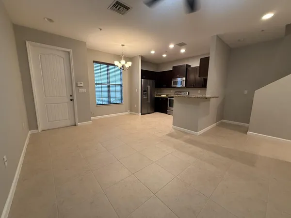 a view of kitchen with kitchen island and stainless steel appliances