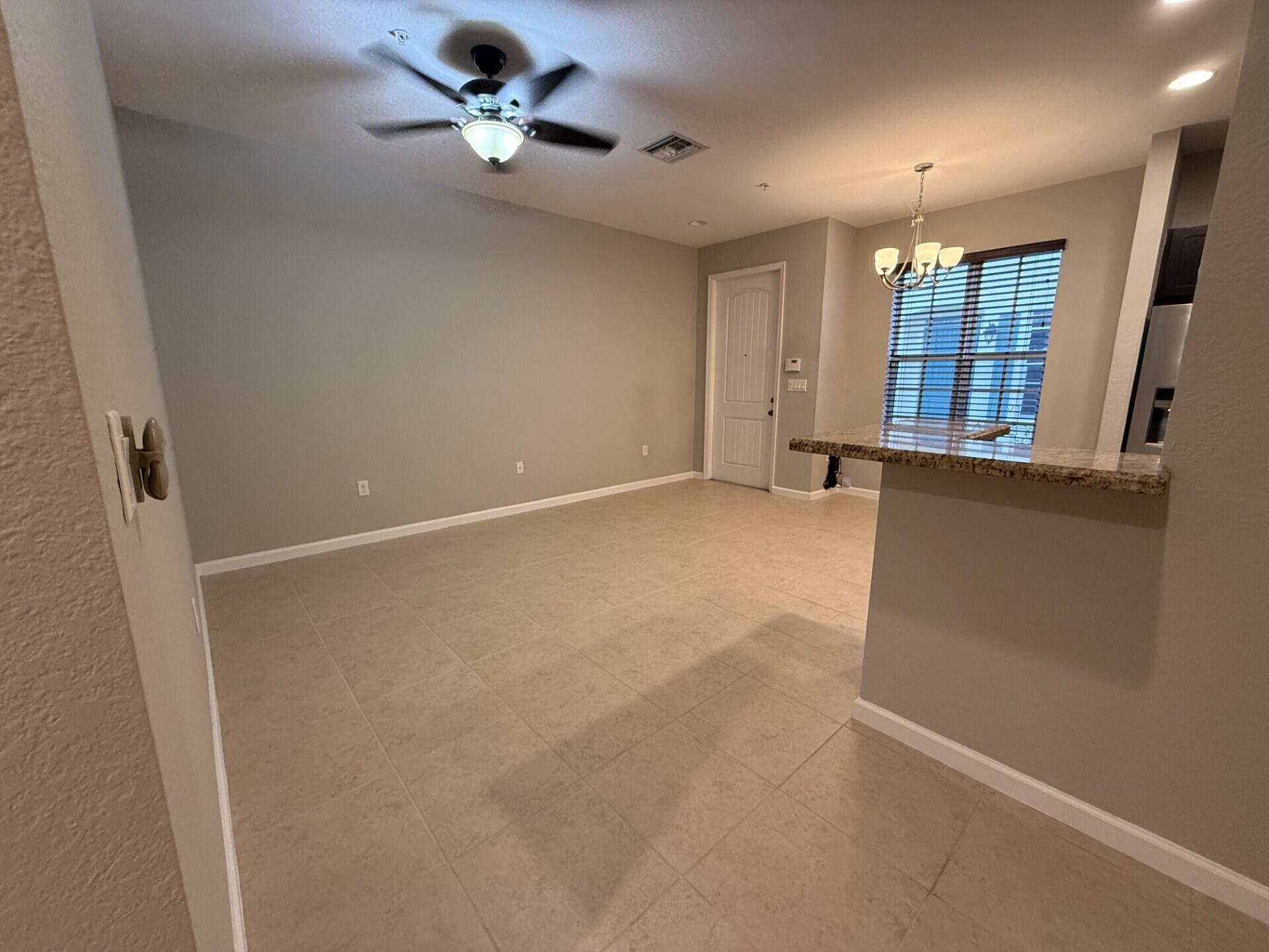 704 Southwest 2nd Way Pompano Beach, FL 33060 - Photo 5 of 22 an empty room with windows and fan