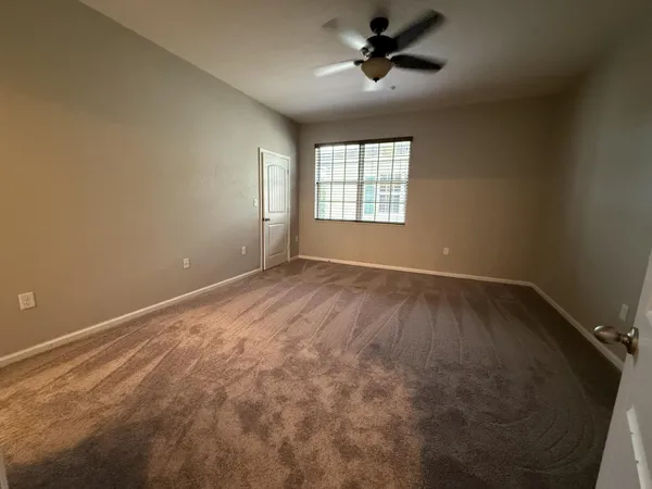 an empty room with a empty space and windows