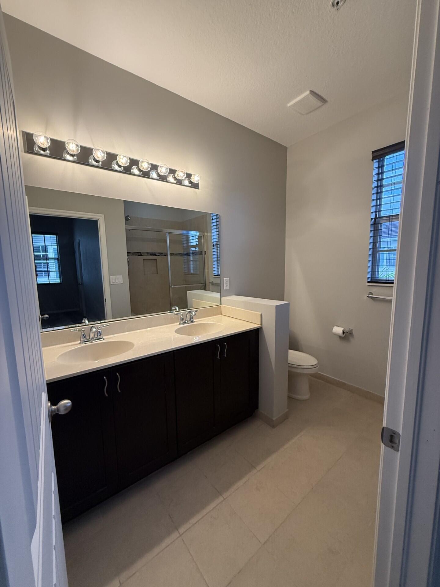 704 Southwest 2nd Way Pompano Beach, FL 33060 - Photo 8 of 22 a bathroom with a sink and a mirror