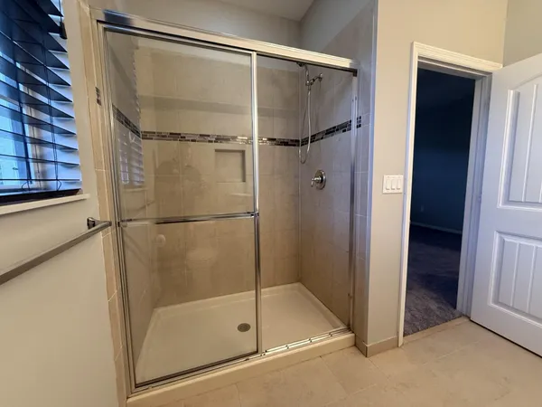 a bathroom with a glass shower door