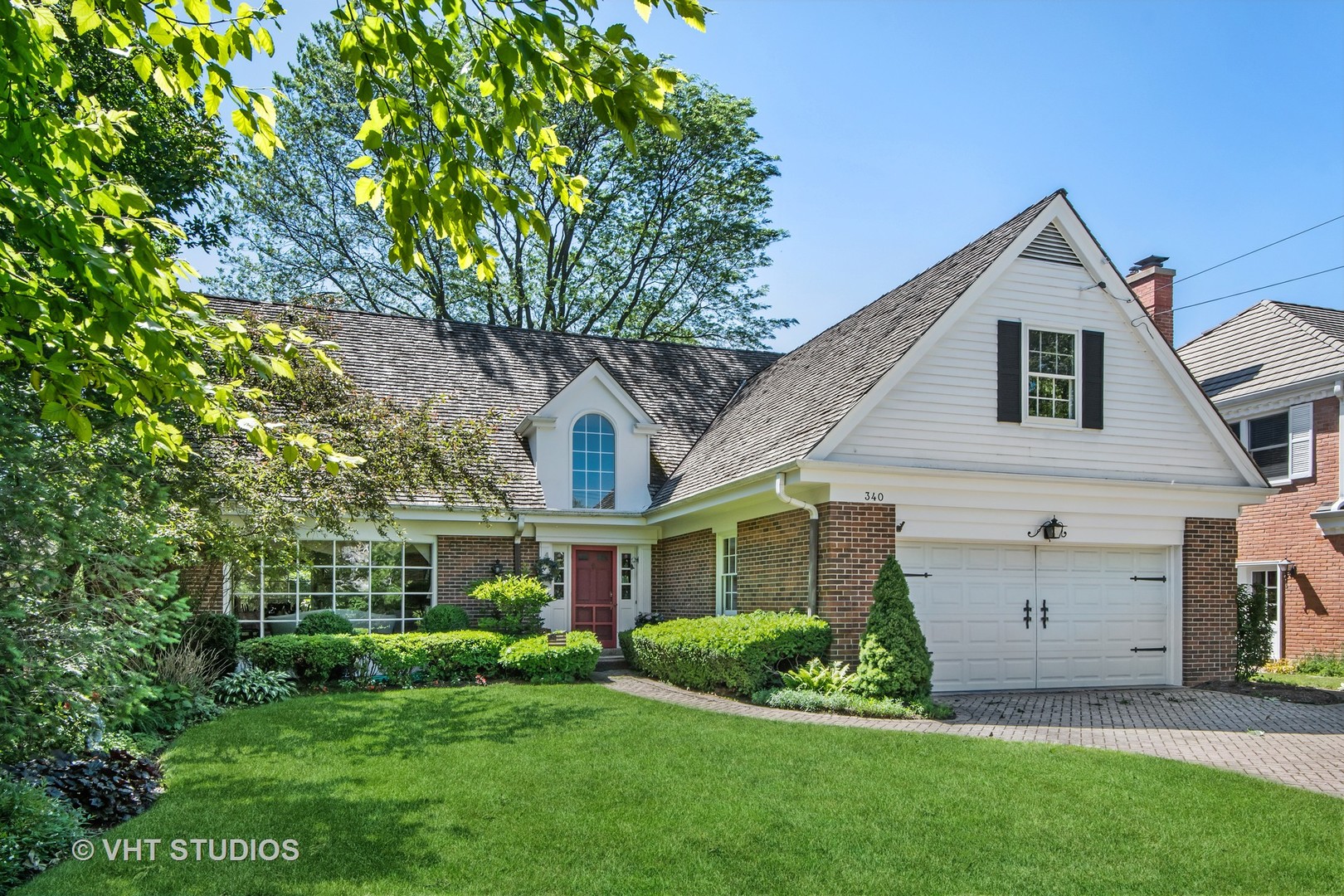 340 Ridge Avenue Winnetka, IL 60093 - Photo 25 of 29 a front view of a house with a yard and garage