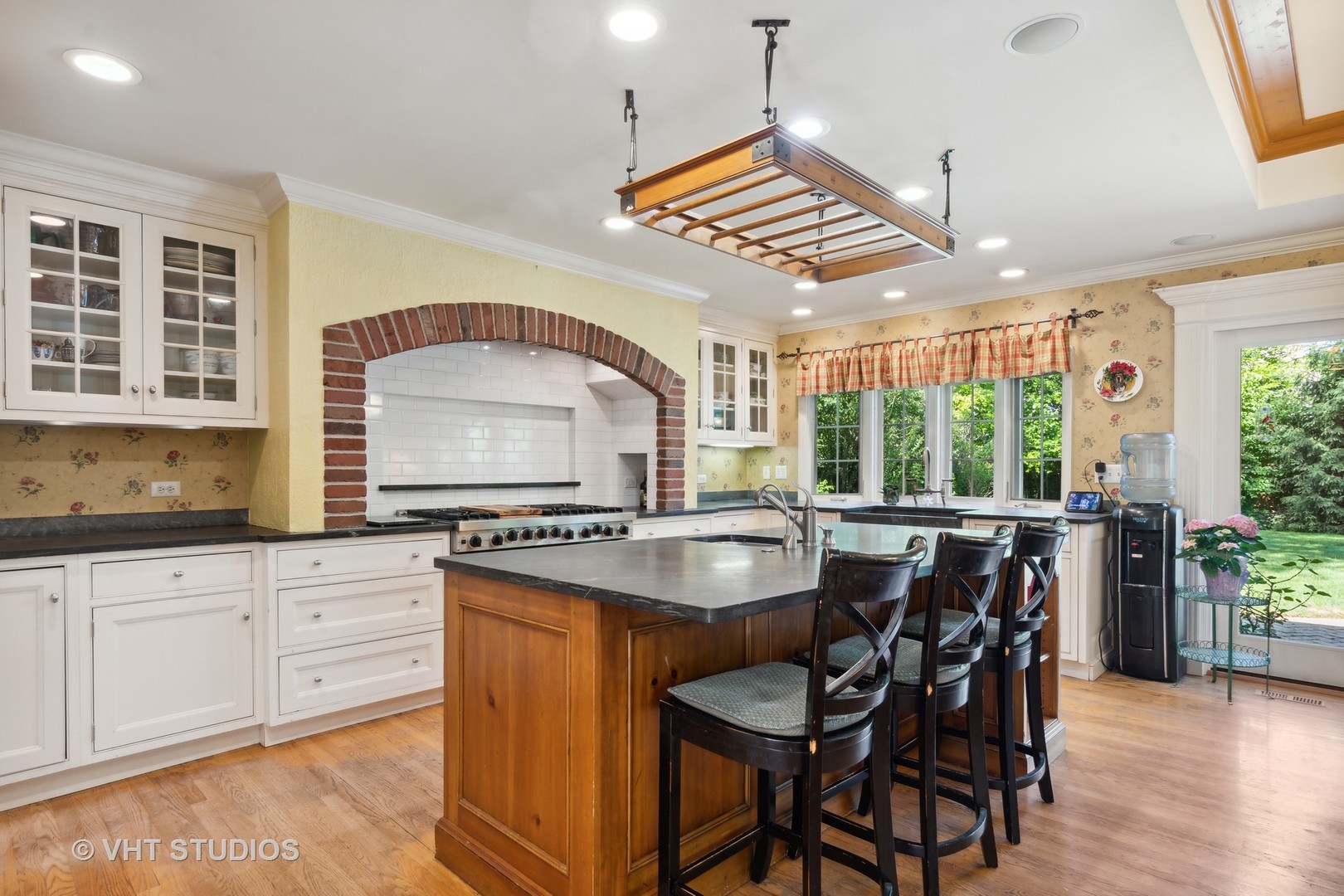 340 Ridge Avenue Winnetka, IL 60093 - Photo 5 of 29 a kitchen with stainless steel appliances granite countertop a stove a kitchen island a table and chairs