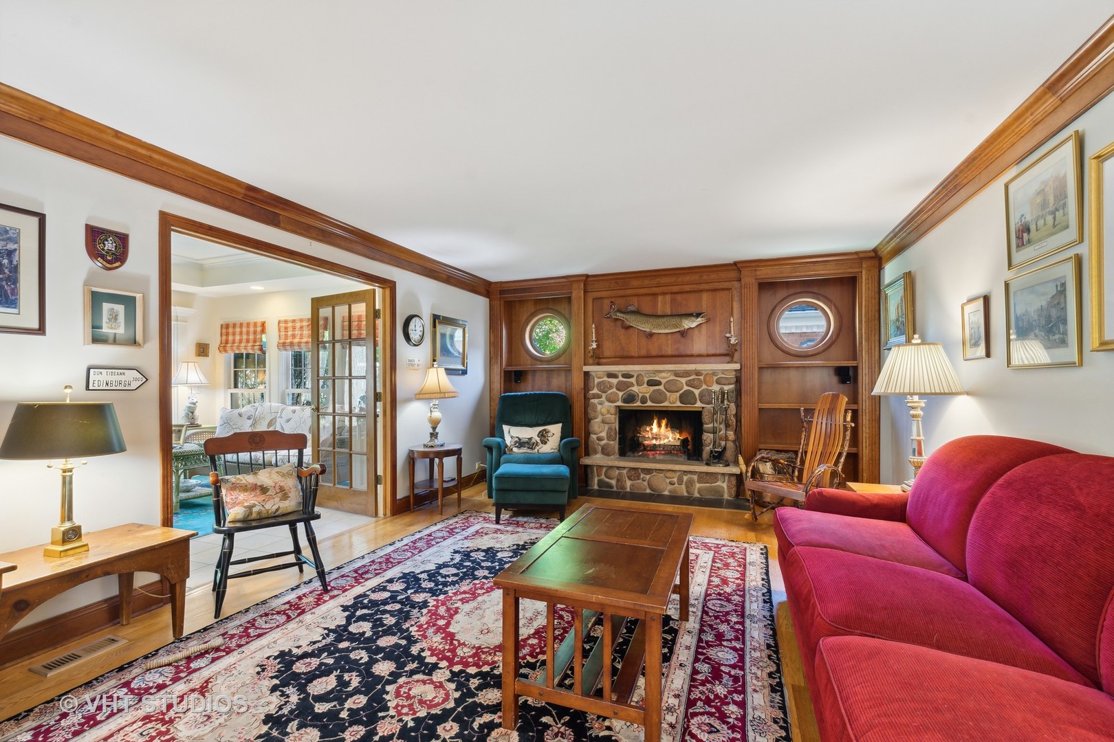 340 Ridge Avenue Winnetka, IL 60093 - Photo 7 of 29 a living room with furniture a fireplace and a large window