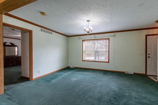 an empty room with a empty space and windows