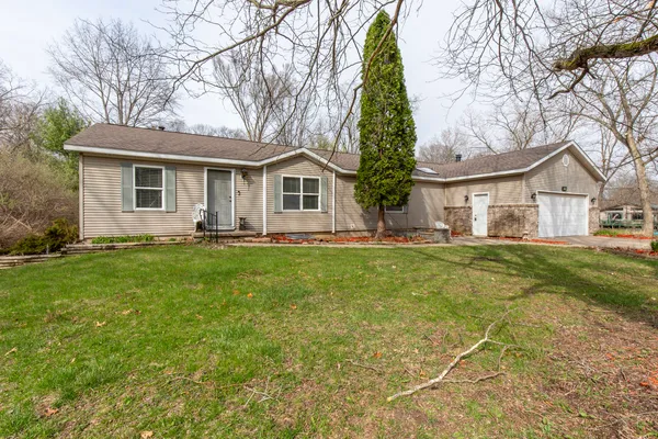 a front view of house with yard and green space