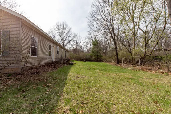 a view of a house with a yard and a garden