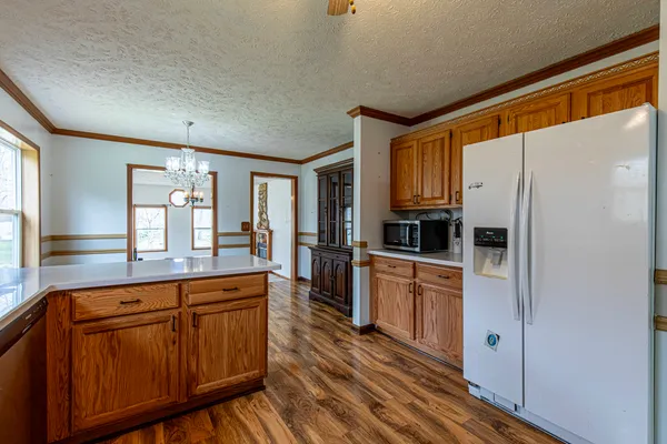 a kitchen with stainless steel appliances a refrigerator and a stove top oven