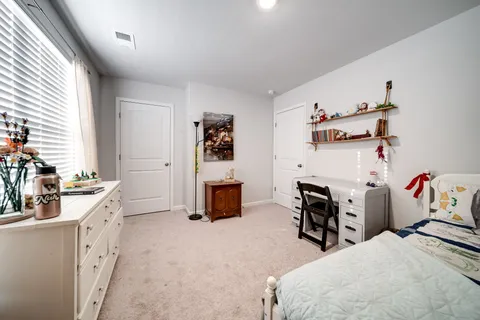 a bedroom with furniture and a fireplace