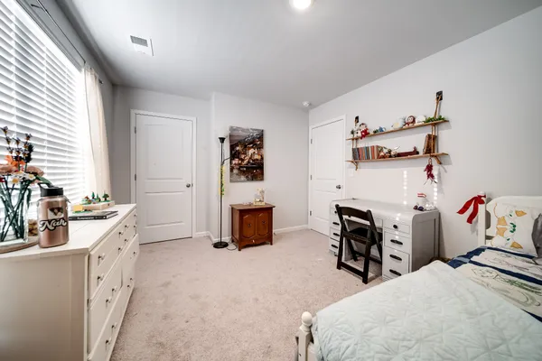 a bedroom with furniture and a fireplace