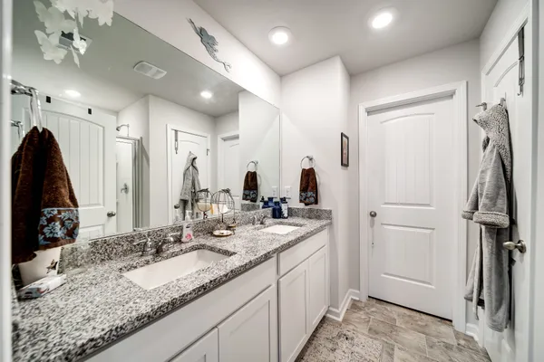 a bathroom with a sink double vanity and a mirror