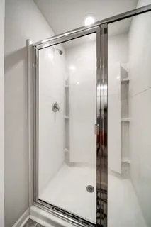 a bathroom with a glass shower door