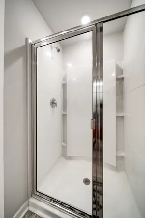 a bathroom with a glass shower door