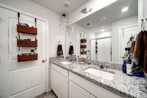 a bathroom with a sink double vanity and a mirror