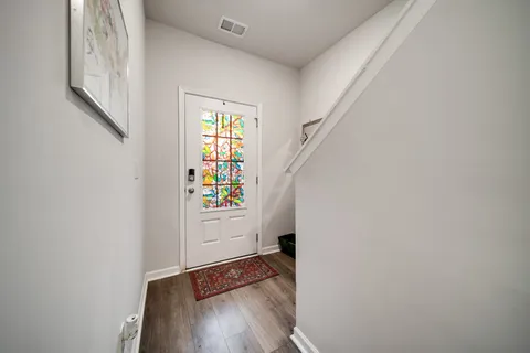 a view of an entryway with wooden floor