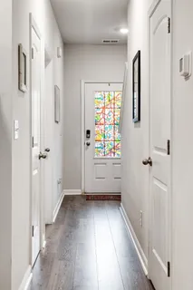a view of an entryway with wooden floor and garden