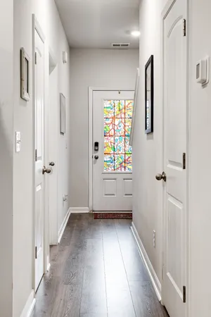 a view of an entryway with wooden floor and garden