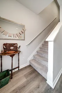 a view of entryway and hall with wooden floor