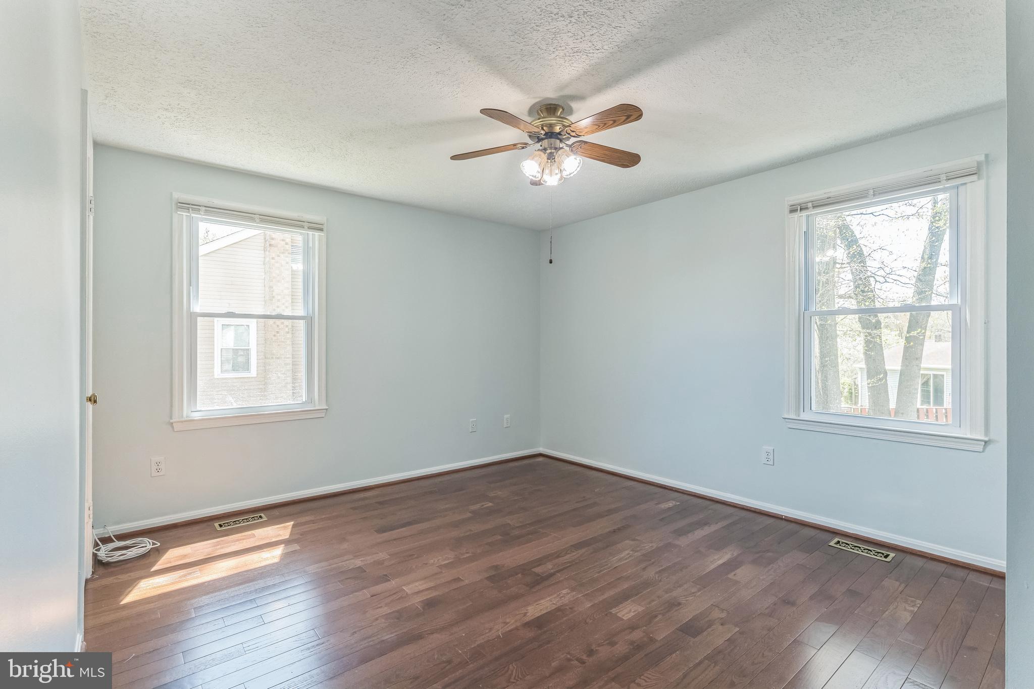 13106 North Point Lane Laurel, MD 20708 - Photo 12 of 30 a view of an empty room with wooden floor and a window