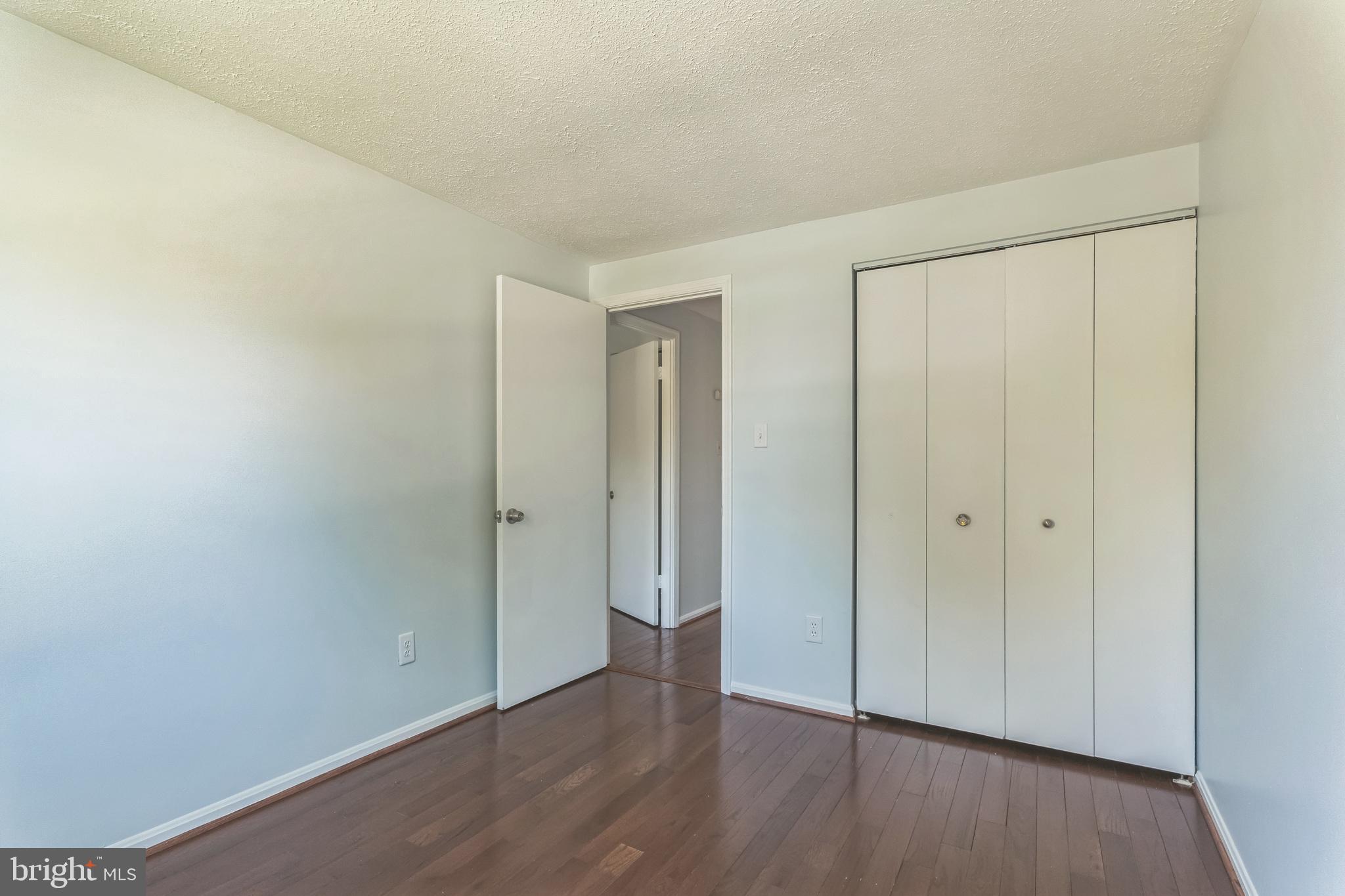 13106 North Point Lane Laurel, MD 20708 - Photo 17 of 30 an empty room with wooden floor and closet area