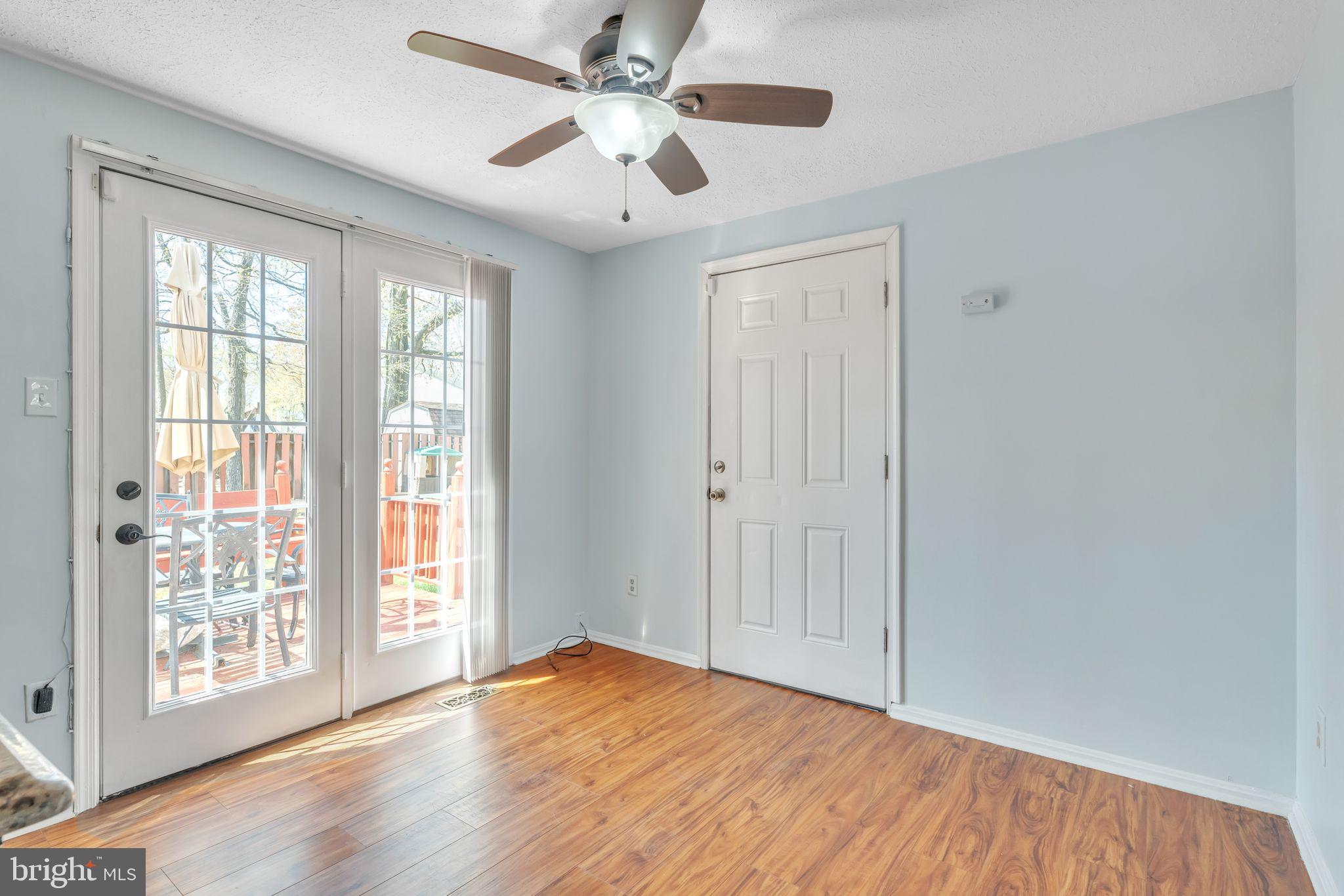 13106 North Point Lane Laurel, MD 20708 - Photo 4 of 30 a view of an empty room with wooden floor and a window