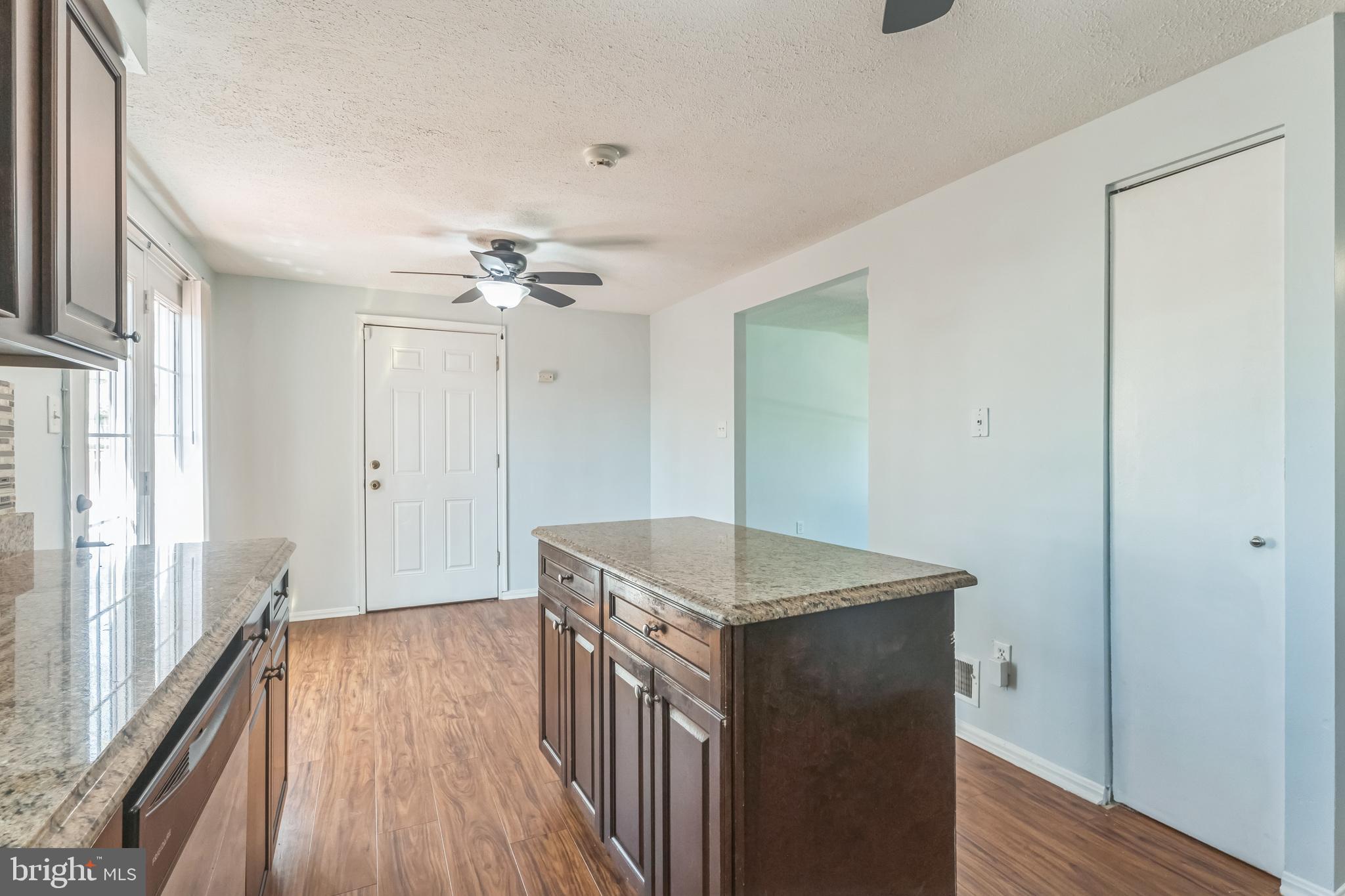 13106 North Point Lane Laurel, MD 20708 - Photo 5 of 30 a hallway with a stove top oven and chandelier