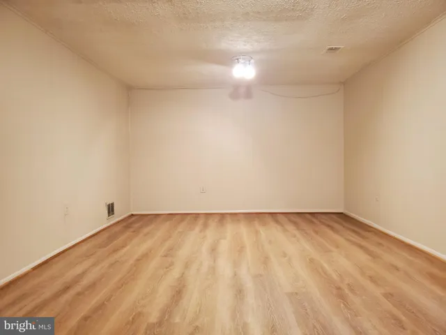 a view of an empty room and wooden floor