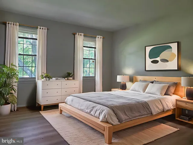 a bedroom with a bed and a potted plant