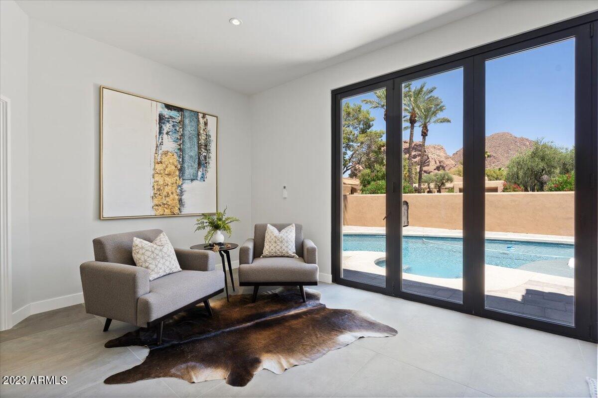 4440 East Camelback Road, Unit 31 Phoenix, AZ 85018 - Photo 17 of 35 a living room with furniture and a floor to ceiling window