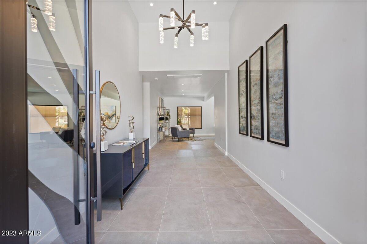 4440 East Camelback Road, Unit 31 Phoenix, AZ 85018 - Photo 4 of 35 en view interior of a house with wooden floor windows and a chandelier