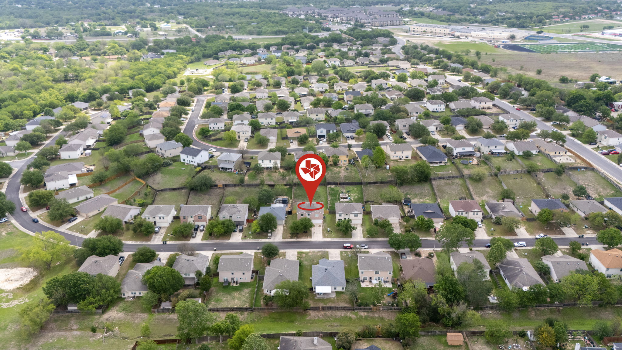 208 Dandelion Loop Kyle, TX 78640 - Photo 3 of 39 Aerial view of the property and its surrounding neighborhood with mature trees