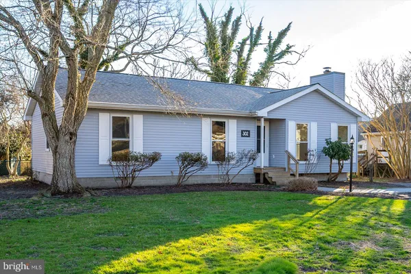 a front view of house with a garden and patio