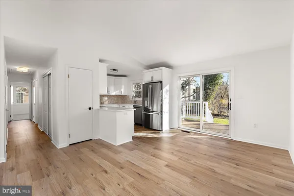 a view of a kitchen with wooden floor and a window