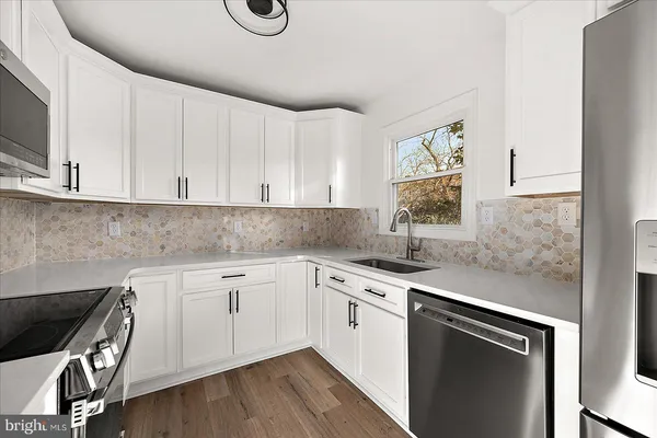 a kitchen with a sink stove and cabinets