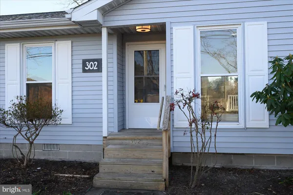 a front view of a house with outdoor seating