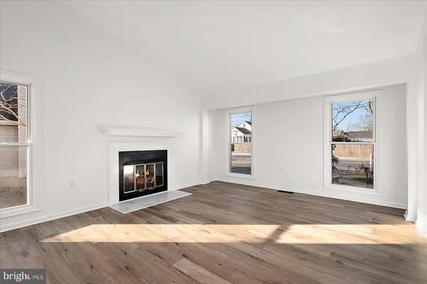 a view of empty room with a fireplace