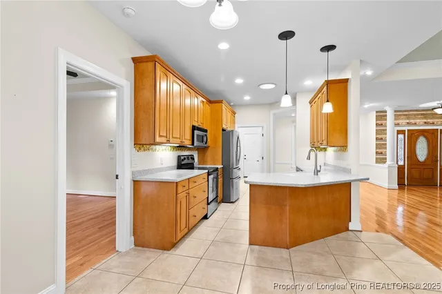 a kitchen with stainless steel appliances granite countertop a sink a counter top space cabinets and stainless steel appliances