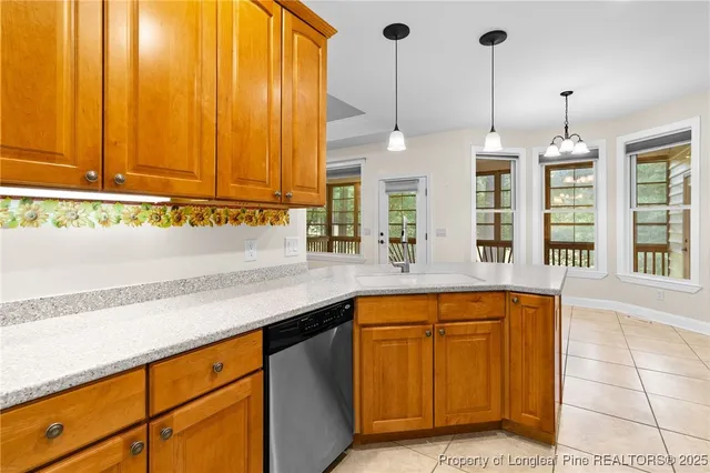 a kitchen with stainless steel appliances granite countertop a sink a counter space and cabinets