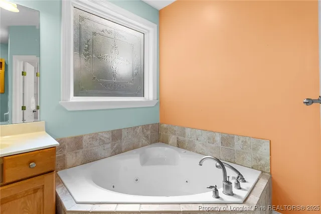 an empty room with closet and a chandelier fan