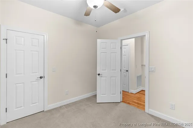 an empty room with closet and wooden floor