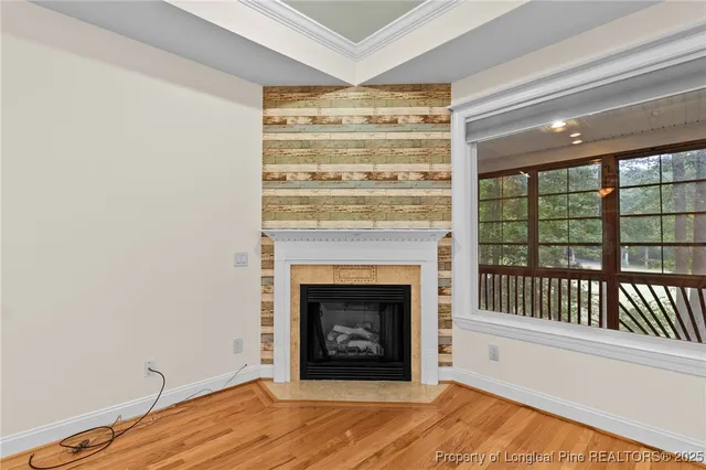 a view of a livingroom with a fireplace and window