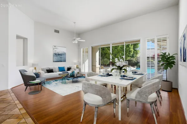 a living room with furniture a rug and a window