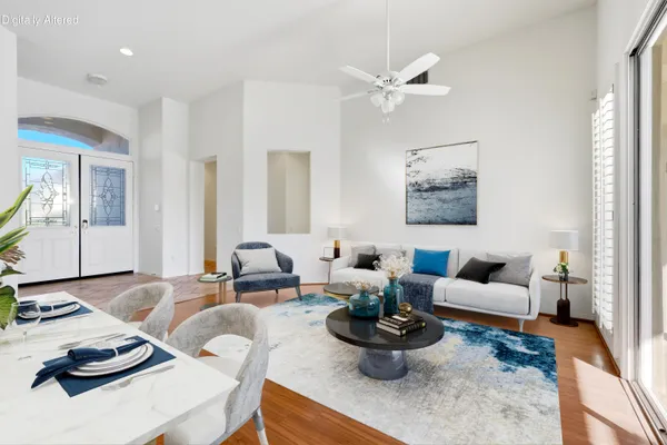 a view of a dining room with furniture and wooden floor