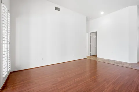 a large kitchen with kitchen island a large counter top stainless steel appliances and cabinets