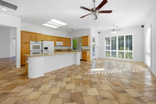 a kitchen with stainless steel appliances a sink cabinets and wooden floor