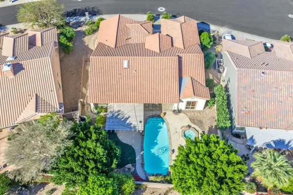 a view of a backyard with plants and outdoor seating