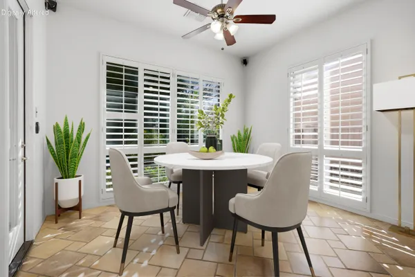 a bedroom with a bed television and a large window